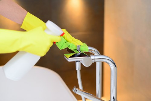 Cleaner maintaining a shared entrance hallway in a Marylebone apartment block